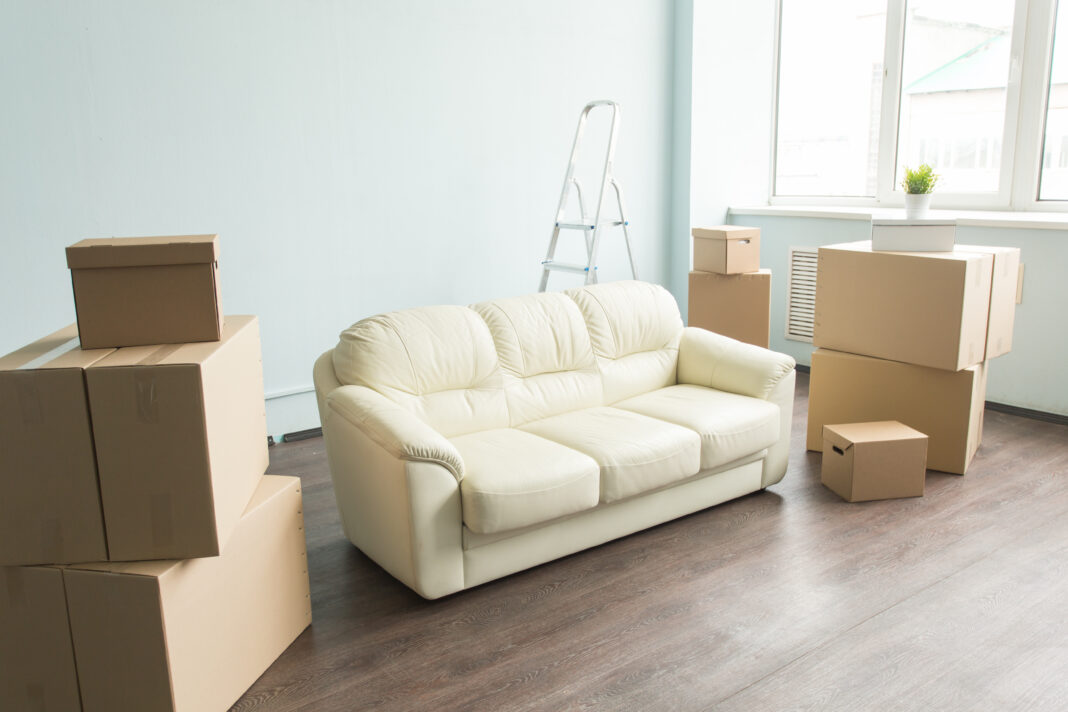 a new white soft sits in a family room surrounded by boxes