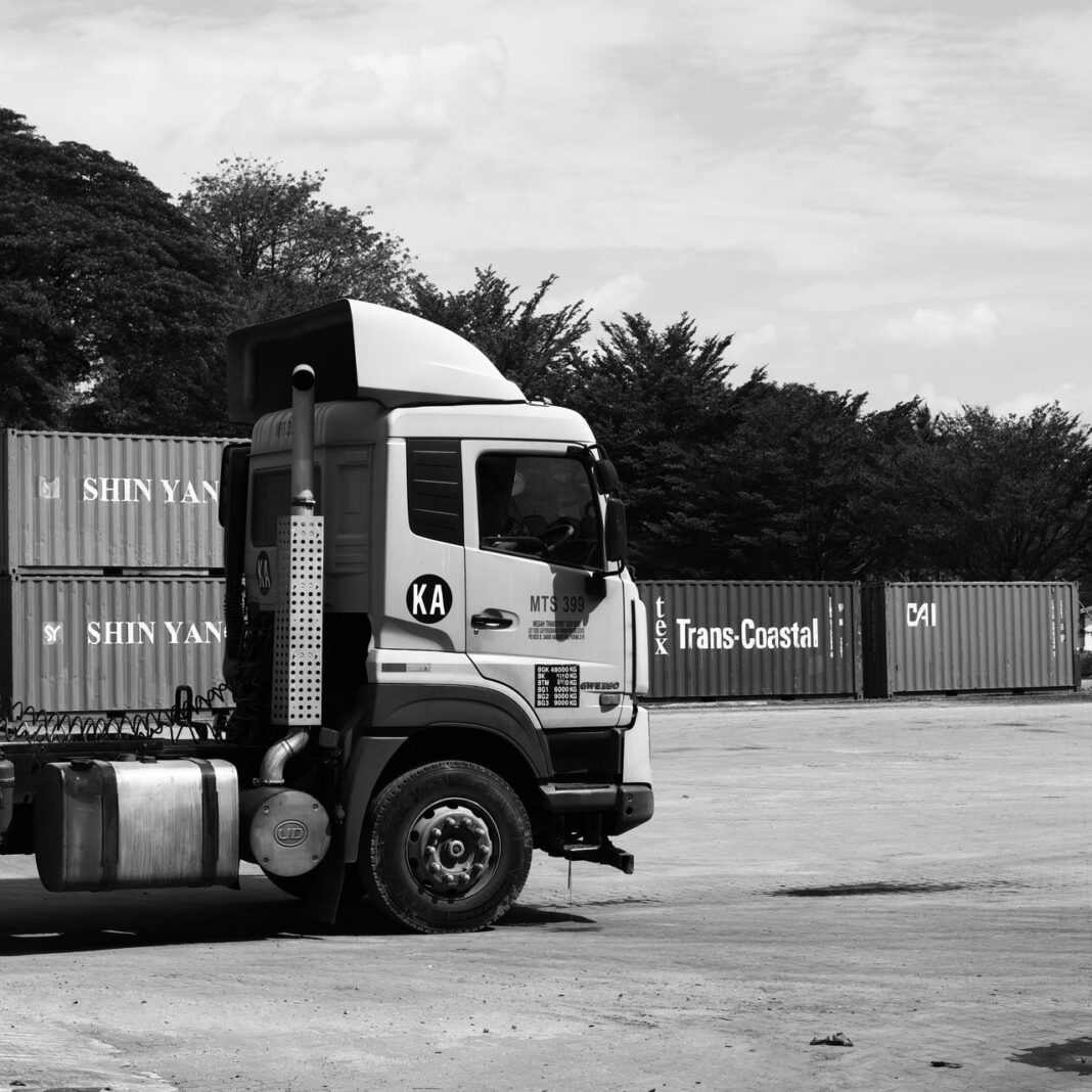 Photo by DuaEnam KosongLima : https://www.pexels.com/photo/black-and-white-truck-at-shipping-yard-in-malaysia-37186960/
